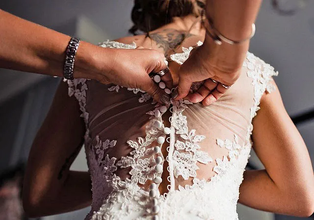 A wedding dress being worked on