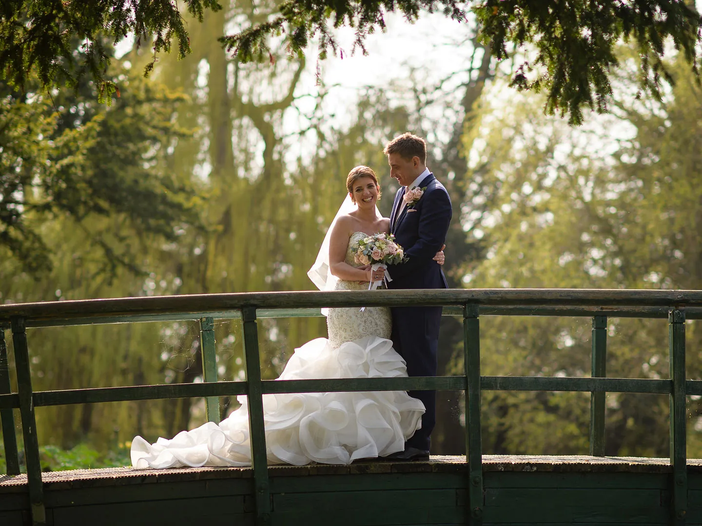 A couple stood on a bridge 