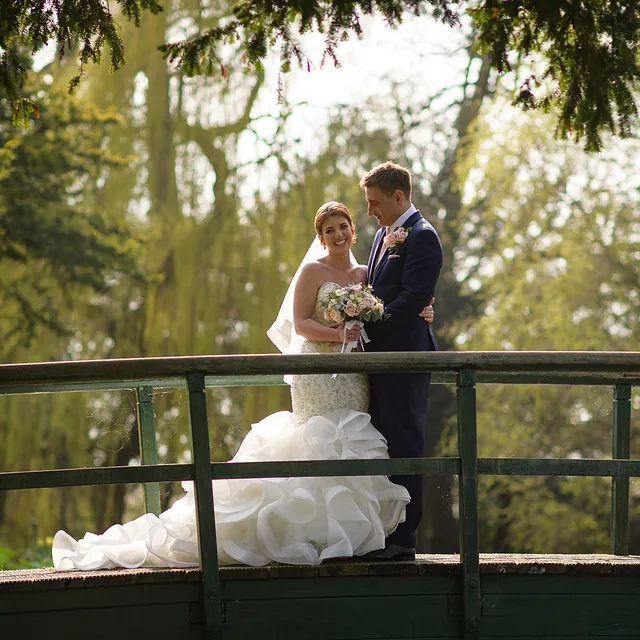 A couple stood on a bridge 