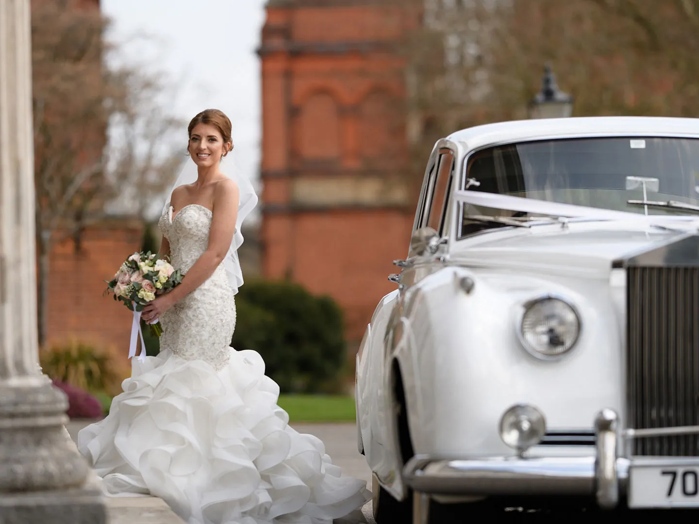 A bride near a car